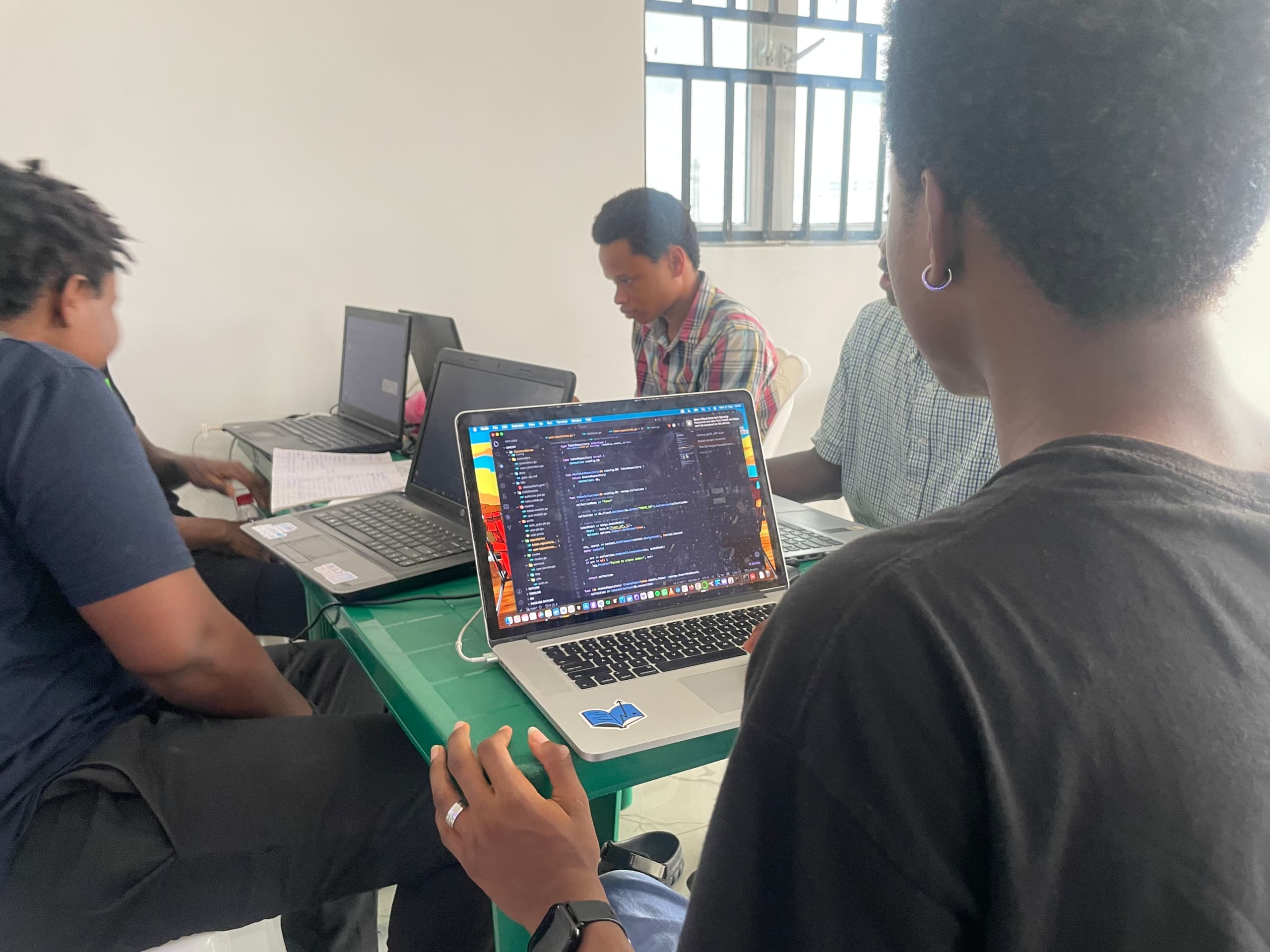 Crew heads-down and coding on laptops at Square One